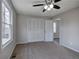 Comfortable carpeted bedroom with windows, a closet, and a ceiling fan at 58 Knox Rd, Powder Springs, GA 30127
