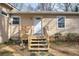 Front entrance with white door and wooden steps, blending curb appeal with practical access to the cozy home at 58 Knox Rd, Powder Springs, GA 30127
