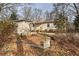 Cozy one-level home featuring a small wooden porch and surrounded by well-maintained landscaping and mature trees at 58 Knox Rd, Powder Springs, GA 30127