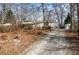 Charming single-story home with gravel driveway, and storage shed surrounded by landscaping at 58 Knox Rd, Powder Springs, GA 30127