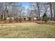 The front yard has grass and mature trees surrounding the home at 58 Knox Rd, Powder Springs, GA 30127