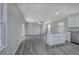 Open floor plan with new kitchen and island seating, opening into living area with wood laminate flooring at 58 Knox Rd, Powder Springs, GA 30127