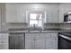 Kitchen features white cabinets, stainless steel appliances, and granite countertops at 58 Knox Rd, Powder Springs, GA 30127