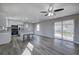 Open-concept kitchen featuring stainless steel appliances, a center island with seating and wood laminate flooring at 58 Knox Rd, Powder Springs, GA 30127