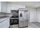 Kitchen features stainless steel appliances, white cabinets, and granite countertops at 58 Knox Rd, Powder Springs, GA 30127