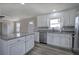 Bright kitchen featuring stainless steel appliances, granite countertops and wood-look floors at 58 Knox Rd, Powder Springs, GA 30127