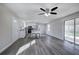 Bright living area with ceiling fan, wood-look floors and a sliding glass door to the outside at 58 Knox Rd, Powder Springs, GA 30127