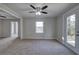 Cozy living room with carpet, natural light, a ceiling fan and an exterior door at 58 Knox Rd, Powder Springs, GA 30127