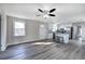 Bright living area with ceiling fan, wood-look floors leading to a full kitchen with island seating at 58 Knox Rd, Powder Springs, GA 30127