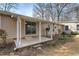 A quaint concrete patio with steps leading to the sliding glass door is surrounded by lush greenery at 58 Knox Rd, Powder Springs, GA 30127