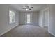 Cozy room features neutral carpet, a ceiling fan, a window, and an exterior door at 58 Knox Rd, Powder Springs, GA 30127