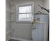 The utility room contains a hot water heater, shelving and a window at 58 Knox Rd, Powder Springs, GA 30127