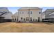 Large backyard boasts a patio area with built-in firepit, perfect for enjoying outdoor gatherings at 6180 Bellmoore Park Ln, Duluth, GA 30097