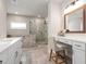 This is a well-appointed bathroom featuring a double vanity, large mirrors, and a glass shower with a separate tub at 6180 Bellmoore Park Ln, Duluth, GA 30097