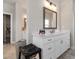 A well-lit bathroom showcases a vanity with white countertops, modern faucets, and a mirror, offering a bright aesthetic at 6180 Bellmoore Park Ln, Duluth, GA 30097