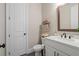 Powder room with white cabinets and decorative mirror at 6180 Bellmoore Park Ln, Duluth, GA 30097