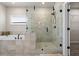 Well-lit bathroom with a glass shower, a garden tub, and neutral tile flooring, designed for relaxation and luxury at 6180 Bellmoore Park Ln, Duluth, GA 30097