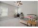Bright bedroom with windows, desk, and a cozy bed, providing a functional and comfortable space for relaxation and productivity at 6180 Bellmoore Park Ln, Duluth, GA 30097