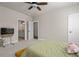 Neutral bedroom with a soft carpet, a ceiling fan, and doors to the ensuite and closet, creating a relaxing retreat at 6180 Bellmoore Park Ln, Duluth, GA 30097