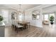 Spacious dining room with wainscoting, modern chandelier, wood floors, and open floor plan at 6180 Bellmoore Park Ln, Duluth, GA 30097