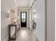 Stylish entryway with wood floors, modern lighting, and a decorative sliding barn door feature at 6180 Bellmoore Park Ln, Duluth, GA 30097