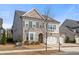 Attractive home with two-car garage, brick and siding exterior, complemented by a well-kept lawn at 6180 Bellmoore Park Ln, Duluth, GA 30097