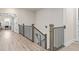Upstairs hallway with dark metal railing and wood bannister, with a view to an office at 6180 Bellmoore Park Ln, Duluth, GA 30097