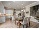 Open concept kitchen featuring white cabinets, stainless appliances, and a dining area at 6180 Bellmoore Park Ln, Duluth, GA 30097