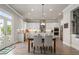 Open kitchen features stainless appliances, white cabinets, large island, and a dining area with patio access at 6180 Bellmoore Park Ln, Duluth, GA 30097
