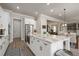 Spacious kitchen with a large central island, stainless steel appliances, and access to other living spaces at 6180 Bellmoore Park Ln, Duluth, GA 30097