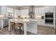 Modern kitchen features white cabinets, stainless appliances, an island with seating, and updated fixtures at 6180 Bellmoore Park Ln, Duluth, GA 30097