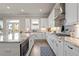 Bright, updated kitchen with an island and stainless steel appliances, flowing into a dining area and outdoor access at 6180 Bellmoore Park Ln, Duluth, GA 30097
