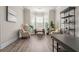 Bright living room with wood floors, bay windows, comfortable seating, and stylish decor at 6180 Bellmoore Park Ln, Duluth, GA 30097