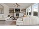 Bright living room featuring a stone fireplace, built-in shelves, and a comfortable white leather sectional at 6180 Bellmoore Park Ln, Duluth, GA 30097