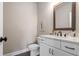 Stylish powder room with a modern vanity, decorative mirror, and a clean design, creating a convenient and elegant space at 6180 Bellmoore Park Ln, Duluth, GA 30097