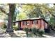 Red brick house with a welcoming front porch surrounded by shade trees at 2075 Dellwood Pl, Decatur, GA 30032