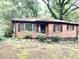 Charming brick home with a cozy, inviting front surrounded by mature trees at 2075 Dellwood Pl, Decatur, GA 30032