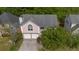 Aerial view of a two-story home with a two-car garage, surrounded by mature trees at 3644 Gray Birch Dr, Decatur, GA 30034