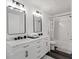 Bathroom with dual vanity, framed mirrors, shower with curtain, and good lighting at 3644 Gray Birch Dr, Decatur, GA 30034