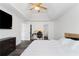 Bright bedroom features a tray ceiling, ceiling fan, and dark wood-look flooring throughout at 3644 Gray Birch Dr, Decatur, GA 30034
