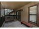 Relaxing outdoor balcony featuring a bench, with views of surrounding greenery through the windows and sliding door at 1804 Cumberland Se Ct, Smyrna, GA 30080