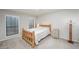 Bright bedroom showcases natural light through two windows, paired with a comfortable, rustic-style bed at 1804 Cumberland Se Ct, Smyrna, GA 30080