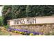 Stone monument sign for Vinings Run community with colorful flowers in a landscaped setting at 1804 Cumberland Se Ct, Smyrna, GA 30080