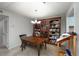 The dining area has a wooden table and chairs with a large bookcase to hold all your favorite books at 1804 Cumberland Se Ct, Smyrna, GA 30080