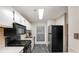 The kitchen has white cabinets, modern appliances, and a sleek gas range for a functional and stylish cooking space at 1804 Cumberland Se Ct, Smyrna, GA 30080