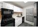 Modern kitchen with a gas range, sleek appliances, white cabinets, and a practical window near the sink at 1804 Cumberland Se Ct, Smyrna, GA 30080