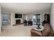 Bright living room with a cozy fireplace, TV and sliding glass doors to a deck offering natural light and air at 1804 Cumberland Se Ct, Smyrna, GA 30080