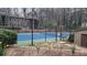 Community tennis court with well maintained court surface and a seating area at 1804 Cumberland Se Ct, Smyrna, GA 30080