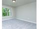 The bedroom's large windows offer natural light at 3118 Old Covington Hwy, Covington, GA 30014