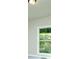 Bedroom showcasing view out of a bright window with wooded view, white trim and walls at 3118 Old Covington Hwy, Covington, GA 30014